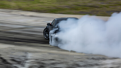 Race car drifting on speed track, Professional driver drifting car on race track with smoke, Abstract texture and background black tire tracks skid on asphalt road, Wheel tire tracks background.