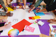© Wavebreak Media - Multiracial male and female design professionals writing ideas on paper during meeting in office