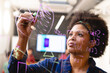 © Wavebreak Media - Young african american female app developer drawing chart on glass in board room