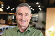 © Wavebreak Media - Portrait of smiling mature caucasian businessman in creative office