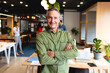 © Wavebreak Media - Portrait of smiling mature caucasian creative businessman standing with arms crossed in office
