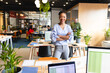 © Wavebreak Media - Portrait of smiling mid adult african american businesswoman with arms crossed in creative office