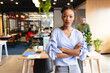 © Wavebreak Media - Portrait of confident mid adult african american businesswoman with arms crossed in office