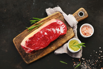 Wall Mural - Raw striploin beef steak dark background.