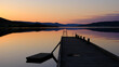 Norwegian lake at sunset with silhouette of pier, Jevnaker, Norway