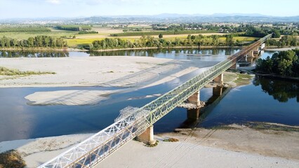 Italy -  drought and aridity in the almost waterless Po river with large expanses of sand and no water - climate change and global warming, Drone view in Ponte bella Becca Pavia Lombardy and Ticino