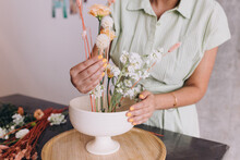 Midsection Of Woman Holding Vase, Working On A Ikebana Center Piece