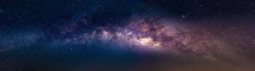Wall Mural - milky way in the night sky and stars on dark background with noise and grain. photo taken with long 