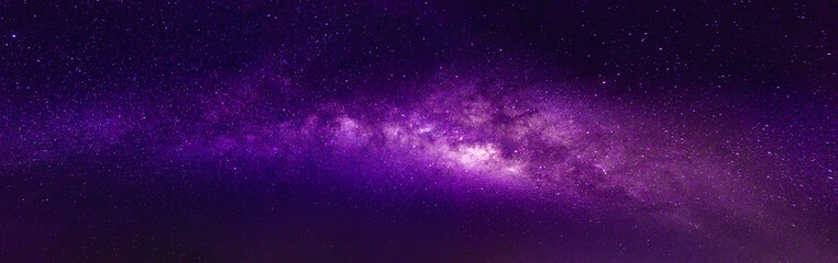 Wall Mural - milky way in the night sky and stars on dark background with noise and grain. photo taken with long 