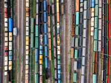 Aerial Photo Of Railway Lines. Freight Wagons With Goods On Railroad Station. Cargo Transportation.