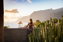 Woman Looking At Sunset Over The Ocean In  Tenerife Canary Islands