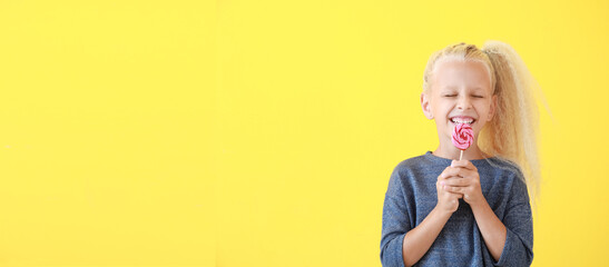 Canvas Print - Cute little girl with lollipop on yellow background with space for text