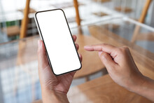 Mockup Image Of A Woman Holding And Touching On Mobile Phone With Blank Desktop Screen In Cafe