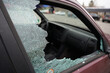 © Milan - Broken side window in car by burglar to get valuables, robbery or driving accident concept
