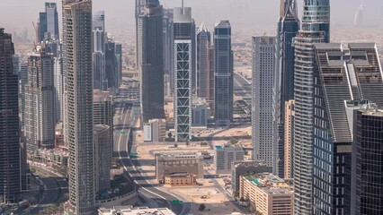 Wall Mural - Downtown skyline with modern architecture form above timelapse during all day. Aerial view of Dubai business bay towers with shadows moving fast