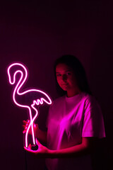 Wall Mural - Beautiful girl with neon signs. Pink neon flamingo. Trendy style. Neon sign. Custom neon. Home decor. 