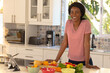 © Wavebreak Media - Portrait of cheerful young african american preparing food in kitchen at home
