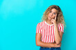 Girl with curly hair isolated on blue background thinking an idea