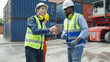 © 2B - Container terminal employees walking and checking container cargo in warehouse