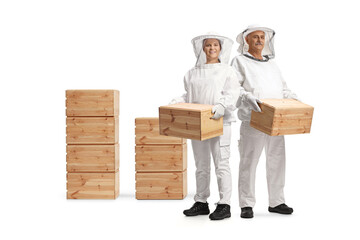 Wall Mural - Male and female bee keepers in uniforms holding wooden crates