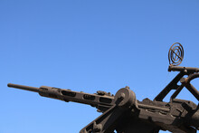 A Machine Gun, Dark Grey/black Pointing Up Into A Blue Sky, Old, Cobwebs On The Sights, Corsica, France