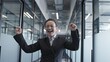 © Synthex - Successful business woman dancing in office, happy with deal, receiving job promotion
