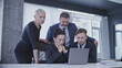 © Synthex - Concentrated colleagues waiting for business project results, looking at laptop screen
