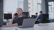 © Synthex - Relaxed business woman having conversation on phone in office, productive day
