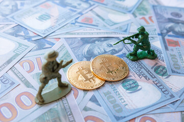 Fight for cryptocurrency concept photo. Figure soldiers and two bitcoins. selective focus.