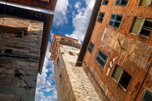 The Torre Delle Ore Clock Tower Seen From The Street Below In The Medieval Walled Town Of Lucca Italy