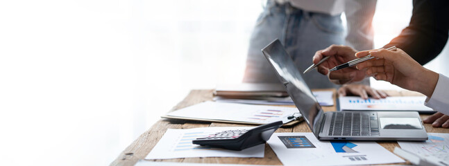 Business team analyzing income charts and graphs with modern laptop computer. Close up.Business analysis and strategy concept.