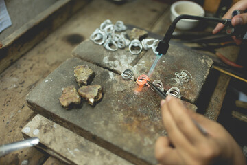 Jeweler at work in jewelry. Desktop for craft jewelry making with professional tools. Close up view of tools. Silver jewelry. Unique local artwork in Nan Province northern thailand