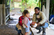© bank215 - African american family enjoy feeding the chicken in the farm. mother and daughter spend time together at chicken organic farm.