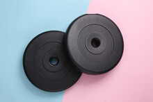 Barbell Plastic Disks On A Blue-pink Pastel Background. Bodybuilding And Fitness. Top View