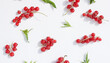  Ripe red currant berries and mint leaves on a white, pastel background.Flat lay, top view,