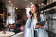 © whyframeshot - smart business owner asian female startup entrepreneur small business manager businesswoman wear smart casual cloth smile hand use tablet smartphone working inventory checking in showroom studio