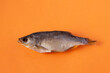 dried fish - rudd on an orange background, isolate