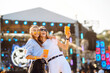 © maxbelchenko - Two young woman drinking beer and having fun at Beach party together. Happy girlfriends  having fun at music festival. Summer holiday, vacation concept.