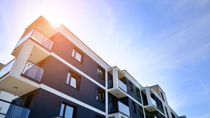 Wall Mural - Modern luxury residential flat. Modern apartment building on a sunny day. Apartment building with a blue sky. Facade of a modern apartment building.