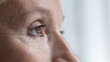 © fizkes - Close up cropped shot, face of senior woman eye looking straight, into distance. Eyesight, ophthalmology clinic advertisement for older, eye-care, disease prevention, vision care and treatment concept