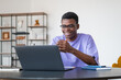 © ImageFlow - African businessman happy on a video conference, talking in office room