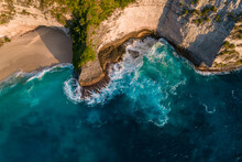 Aerial Drone Top View Shot Of Rocky Beach With Cliff. Indian Ocean Shore. Copy Space For Text. Nature And Travel Background. Beautiful Natural Summer Vacation Travel Concept. Waves And Sand.