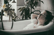 © Denis Kadatsky - woman lies in a bath with foam