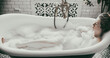 © Denis Kadatsky - woman lies in a bath with foam