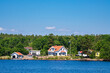canvas print picture Ostseeküste mit Bäumen und Häusern nahe der Insel Uvö in Schweden