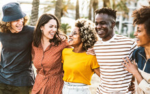 Multiracial Friends Having Fun Hanging Outside Together - Happy Group Of Young People Enjoying Day Out Walking On City Street - Friendship Concept With Guys And Girls Laughing On Summer Holidays