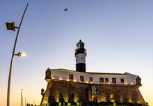 Facade Of The Old And Historic Fort And Lighthouse In Barra Beach During Sunset In The City Of Salvador, Bahia