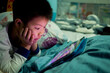 © waranyu - asian chinese boy playing smartphone, kid use phone and play game, addicted game and cartoon