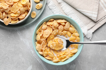 Wall Mural - Tasty cornflakes with milk served on light grey table, flat lay