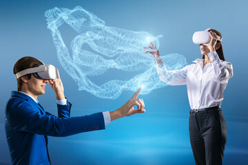 Aufkleber - Attractive young european businessman and woman with VR glasses pointing at creative glowing blue metaverse cloud on blue background. Technology, innovation and augmented reality concept.